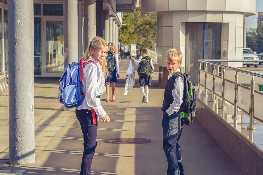 Children with backpacks walking to school.